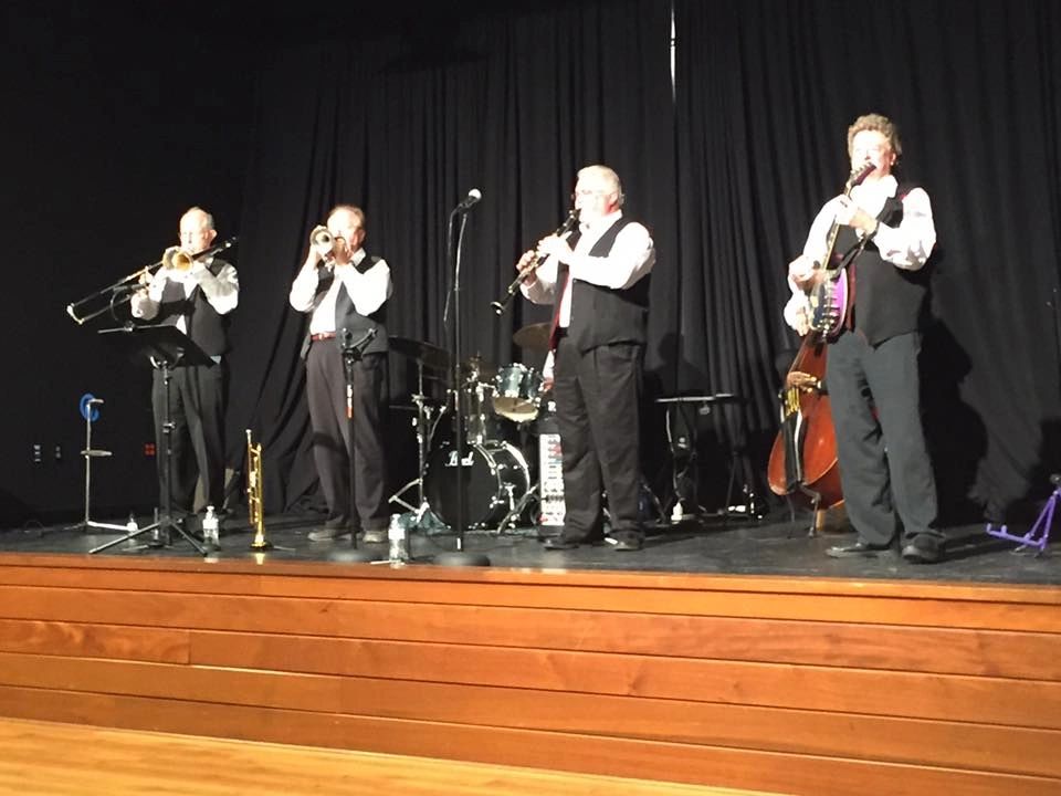 Razzmajazz jazz band performing with red curtain backdrop
